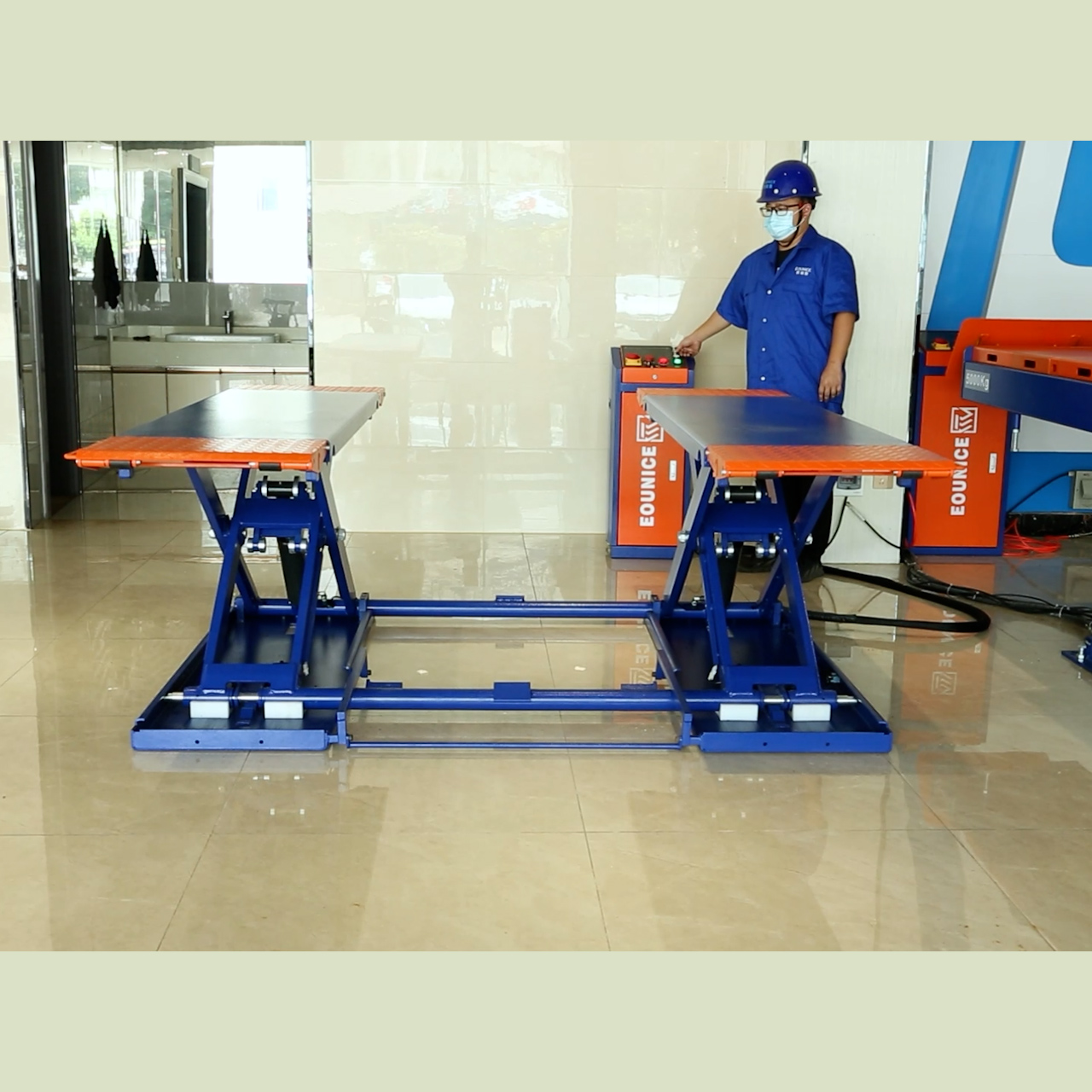 Full extension view of the Eounice portable scissor car lift station achieving its maximum 1-meter lifting height for tire and brake service.